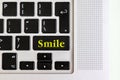 Top view isolated laptop keyboard with yellow `smile` text on button, concept design v Royalty Free Stock Photo