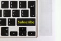 Top view isolated laptop keyboard with yellow `subscribe` text on button, concept design v Royalty Free Stock Photo