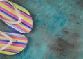 Top view on isolated pair colorful striped flip flops on blue background with copy space Royalty Free Stock Photo