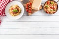 Top of view italian pasta spaghetti bolognese in plate and pan with tomatoes and basil