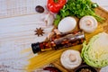 Top view on italian pasta, vegetable, olive oil in bottle, mushrooms, tomatos, egg, parsley, bad, nutmeg, chilli on white wooden.