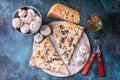 Top view italian pizza with mushrooms and cheese on a round board. Fork, knife and napkin. Pizza time concept Royalty Free Stock Photo