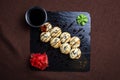 top view Japanese cuisine, rolls with cheese and sesame seeds and soy sauce on a black plate Royalty Free Stock Photo