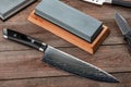 Top view on a Japanese Gyuto knife, a jackknife and a whetstone Royalty Free Stock Photo