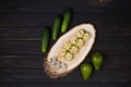 Top view of rice free sushi roll with crunchy tempura shrimp wrapped in cucumber slices served with black tiger shrimps on wood Royalty Free Stock Photo