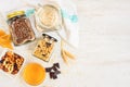 Top view of jars full of oats and various crunchy granola - plain, dried fruits, nuts and chocolate. Healthy eating concept. Copy Royalty Free Stock Photo