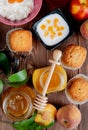 top view of jars of jams as peach and plum with cupcakes peaches cottage cheese on wooden background