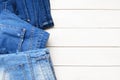 Top view jeans on a light wooden background. Detail of nice blue jeans. Jeans texture or denim background. Royalty Free Stock Photo