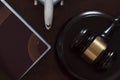 Top view of Judge`s gavel, passport and airplane