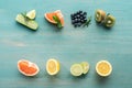 Top view of juicy fruits and blueberries on blue textured surface. Royalty Free Stock Photo