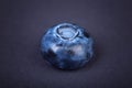 Top view of a juicy, healthful and tasty blueberry on a dark background. Fresh single blueberry fruit, close-up. Summer fruits.