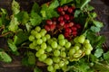 Top view of the juicy and ripe green and red grapes on the wooden surface Royalty Free Stock Photo