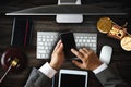 Top view .Justice and law concept.Male judge in a courtroom  the gavel, working with smart phone and laptop and digital tablet Royalty Free Stock Photo