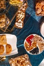 top view of Kazakhstani treats. Delicious pastries and nuts on a blue velvet tablecloth.