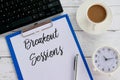 Top view of keyboard,coffee,clock,pen,clipboard and paper written with Breakout Sessions Royalty Free Stock Photo