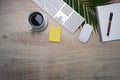 Top view keyboard, coffee cup and notebook on wooden desk.