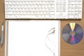 top view of keyboard computer notebook earphone and dvd disk Royalty Free Stock Photo