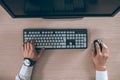 Top view of keyboard with men`s hands. Free black monitor copy space for design Royalty Free Stock Photo