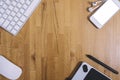 Top view of a keyboard, mouse, graphics tablet, headphones and smartphone with empty blank screen on a background wooden table Royalty Free Stock Photo