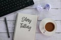 Top view of keyboard,trash paper,coffee,pen and notebook written with Story Telling. Royalty Free Stock Photo