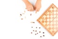 Top view of kid hand and chess board with chess pieces Royalty Free Stock Photo