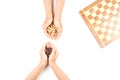 Top view of kid hand and chess board with chess pieces Royalty Free Stock Photo