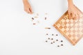 Top view of kid hand and chess board with chess pieces Royalty Free Stock Photo