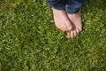 Top view on kid`s bare feet on the green grass. Little boy standing on the grass in the park on a sunny day. Child Royalty Free Stock Photo