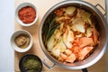 top view of kimchi-making process with cabbage and spices