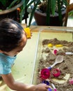 Top view of kinetic sands in a container on the table with a children playing. Selective focus Royalty Free Stock Photo