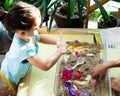 Top view of kinetic sands in a container on the table with a children playing. Selective focus Royalty Free Stock Photo