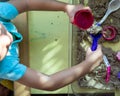 Top view of kinetic sands in a container on the table with a children playing. Selective focus Royalty Free Stock Photo