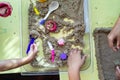 Top view of kinetic sands in a container on the table with a children playing. Selective focus Royalty Free Stock Photo