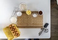 Top view of kitchen equipment with flour, cocoa powd, eggs, and butter for baking a cake