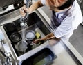 Top view of kitchen staff washing utensils at sink Royalty Free Stock Photo