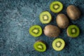 Top view kiwi fruit slices in a gray plate on a stone table with copy space