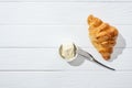 Top view of knife near bowl with cream cheese and croissant on white . Royalty Free Stock Photo