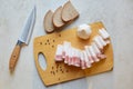 Top view of knife and slices of bread near cutting board, having lard an garlic to taste, Ukrainian traditional appetizer, food Royalty Free Stock Photo