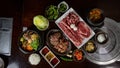Top view Korean Grilled BBQ combo with wagyu and marinated beef set on the traditional grill table