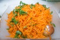 Top view of Korean-style carrots Koryo-saram, spicy pickled carrot in bowl . Salad with fresh carrot and oil . Raw Organic Orange