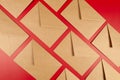 Top view of kraft envelopes on red background.