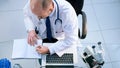 top view. lab scientist using a laptop to save data. Royalty Free Stock Photo