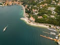 Top view of Lake Lago di Garda and the village of Torbole, alpine scenery. Italy Royalty Free Stock Photo