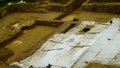 Top view of land with excavations and archaeological surveys with plastic sheets to protect the rain