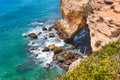 Top view of landscape view of rocks, cliff, sea waves in Algarve, Lagos, Portugal. seagull sitting on a cliff in Atlantic ocean Royalty Free Stock Photo