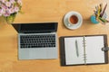 Top view of Laptop with blank screen, pencils, notebook, vase and tea on table in home office. Workspace with laptop and office Royalty Free Stock Photo
