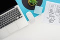 Top view of laptop, computer mouse, plant, website design template on abstract geometric background. Royalty Free Stock Photo