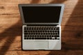 Top view of laptop computer on office desk with blank black mockup screen and copy space Royalty Free Stock Photo