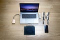 Top view of a laptop with a drawing graphic tablet, a mobile phone, a foldable stand, a ssd hard disk and a hub type C Royalty Free Stock Photo