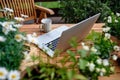 Top view of laptop on table on balcony in summer, outdoors office concept. Royalty Free Stock Photo